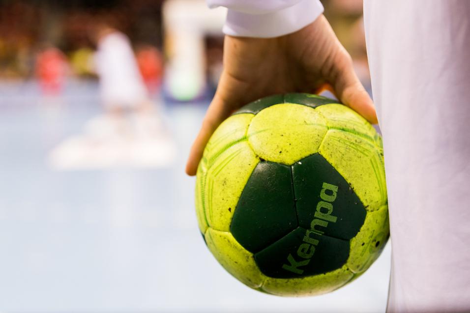Ein Spieler hält einen Handball in der Hand